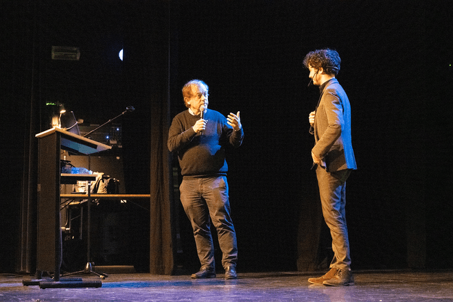 Thomas Winters and Rik Torfs presenting a talk on TorfsBot (automating Rik Torfs with AI)