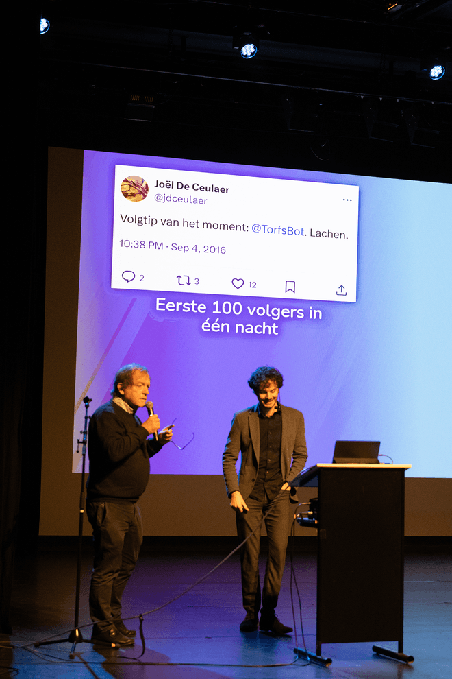 Thomas Winters and Rik Torfs presenting a talk on TorfsBot (automating Rik Torfs with AI)