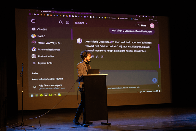 Thomas Winters and Rik Torfs presenting a talk on TorfsBot (automating Rik Torfs with AI)