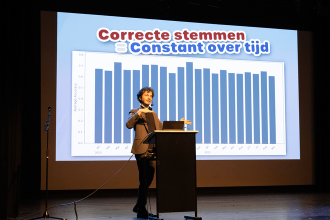 Thomas Winters and Rik Torfs presenting a talk on TorfsBot (automating Rik Torfs with AI)