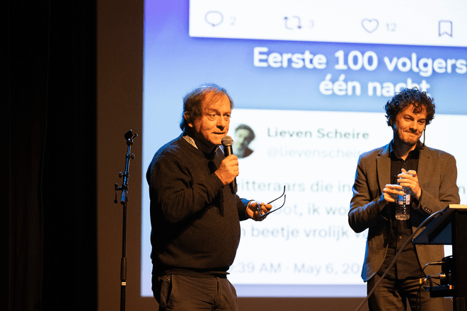 Thomas Winters and Rik Torfs presenting a talk on TorfsBot (automating Rik Torfs with AI)