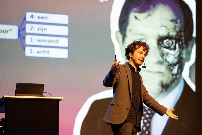 Thomas Winters and Rik Torfs presenting a talk on TorfsBot (automating Rik Torfs with AI)