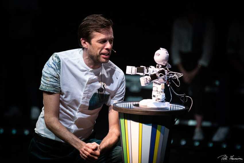 An performer improvising a scene with robot Alex