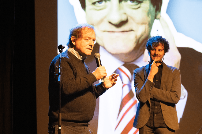 Thomas Winters and Rik Torfs presenting a talk on TorfsBot (automating Rik Torfs with AI)